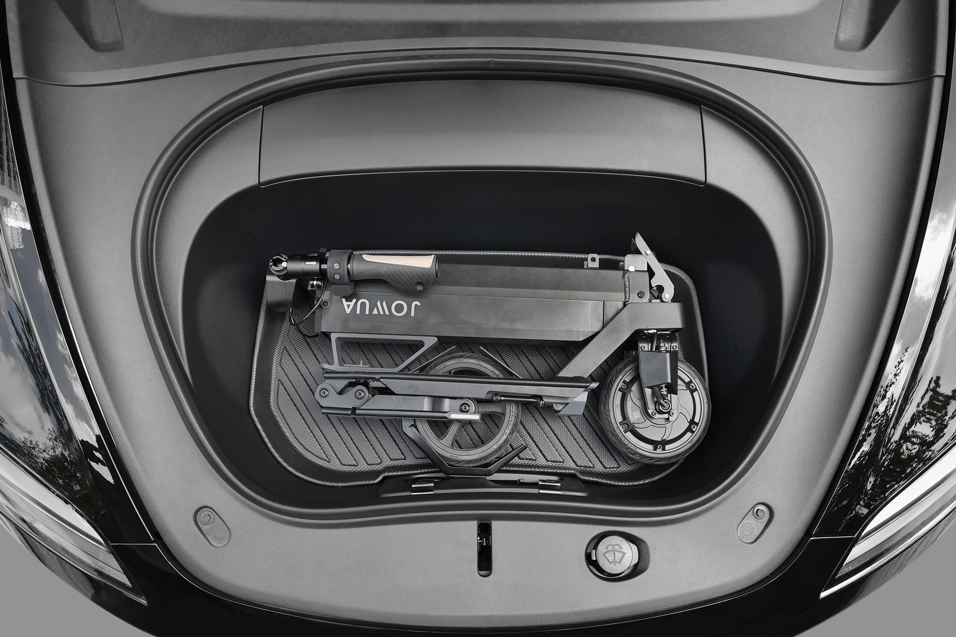 JOWUA Taiwan 折疊電動滑板車|Performance 緊貼車前行李箱,安放在輪廓分明的襯墊上,展現其輕巧設計與便攜性。.