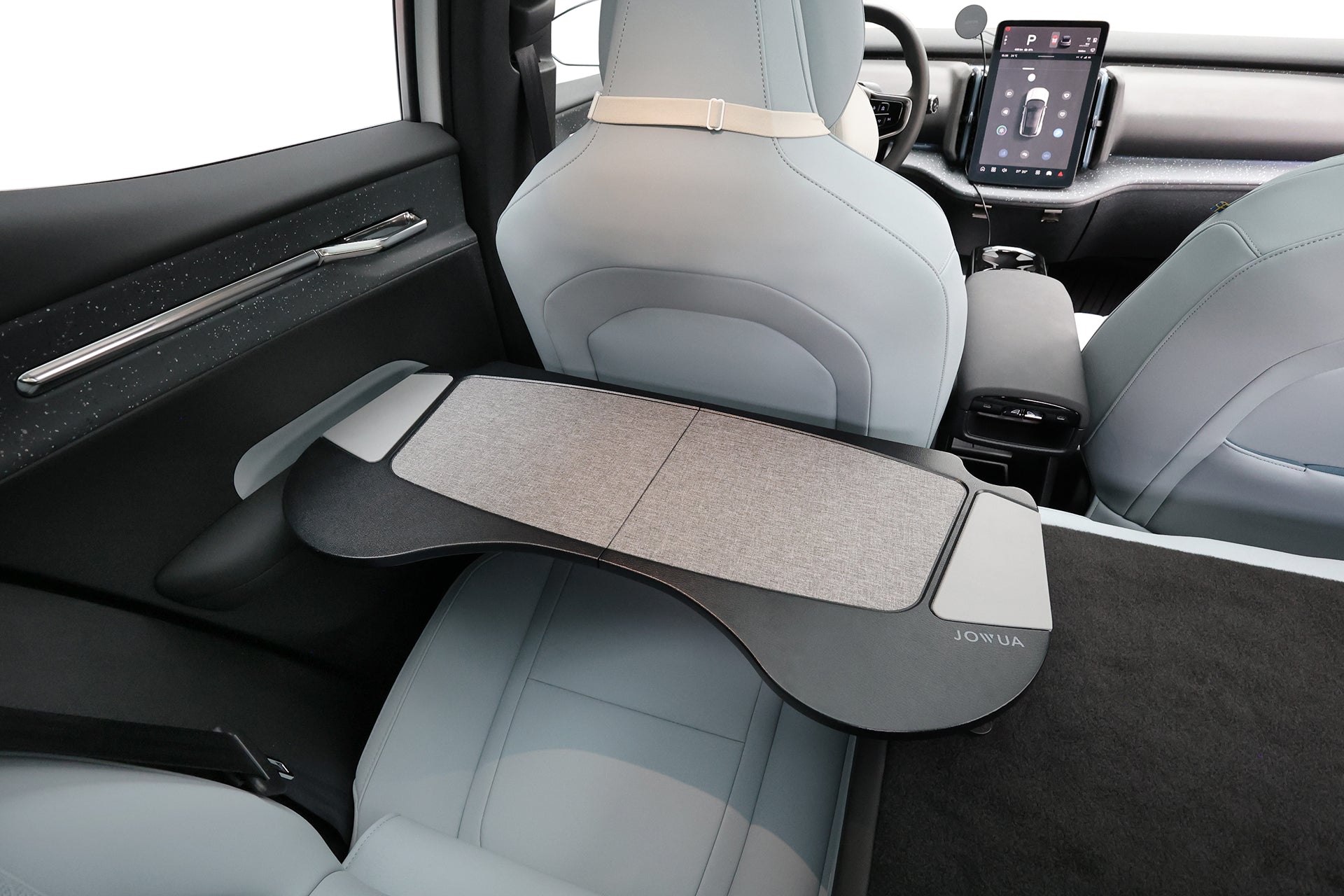 JOWUA Taiwan 車用折疊桌板安裝在現代汽車的前座椅背上,搭配淺灰色的內飾和中央觸控式儀表板,創造出理想的行動辦公桌設定。.