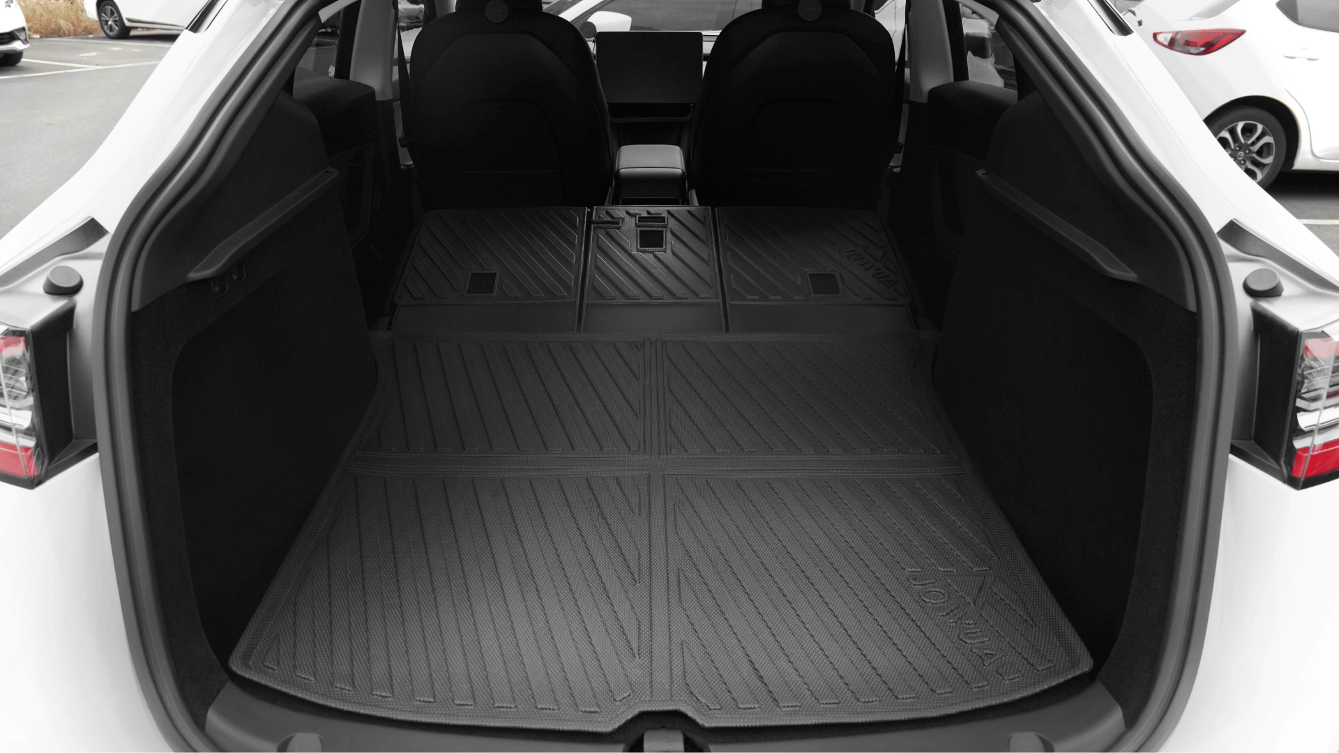 Model Y(2021-2024)的後貨艙區域,座椅折疊,採用台灣 JOWUA 防水後排椅背墊,由 TPE 材質防水製成,保護寬敞的內部並保持清潔。.