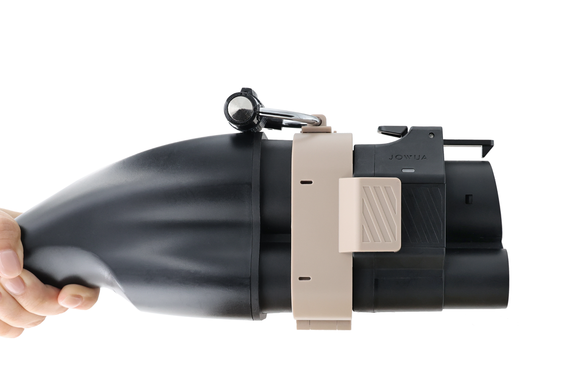 一隻手拿著黑色和米色的 JOWUA Taiwan CCS2 to CCS1 充電防拔鎖扣，這是一個帶手柄和扳機的機械裝置，在純白色背景下，表面光滑且棱角分明。.